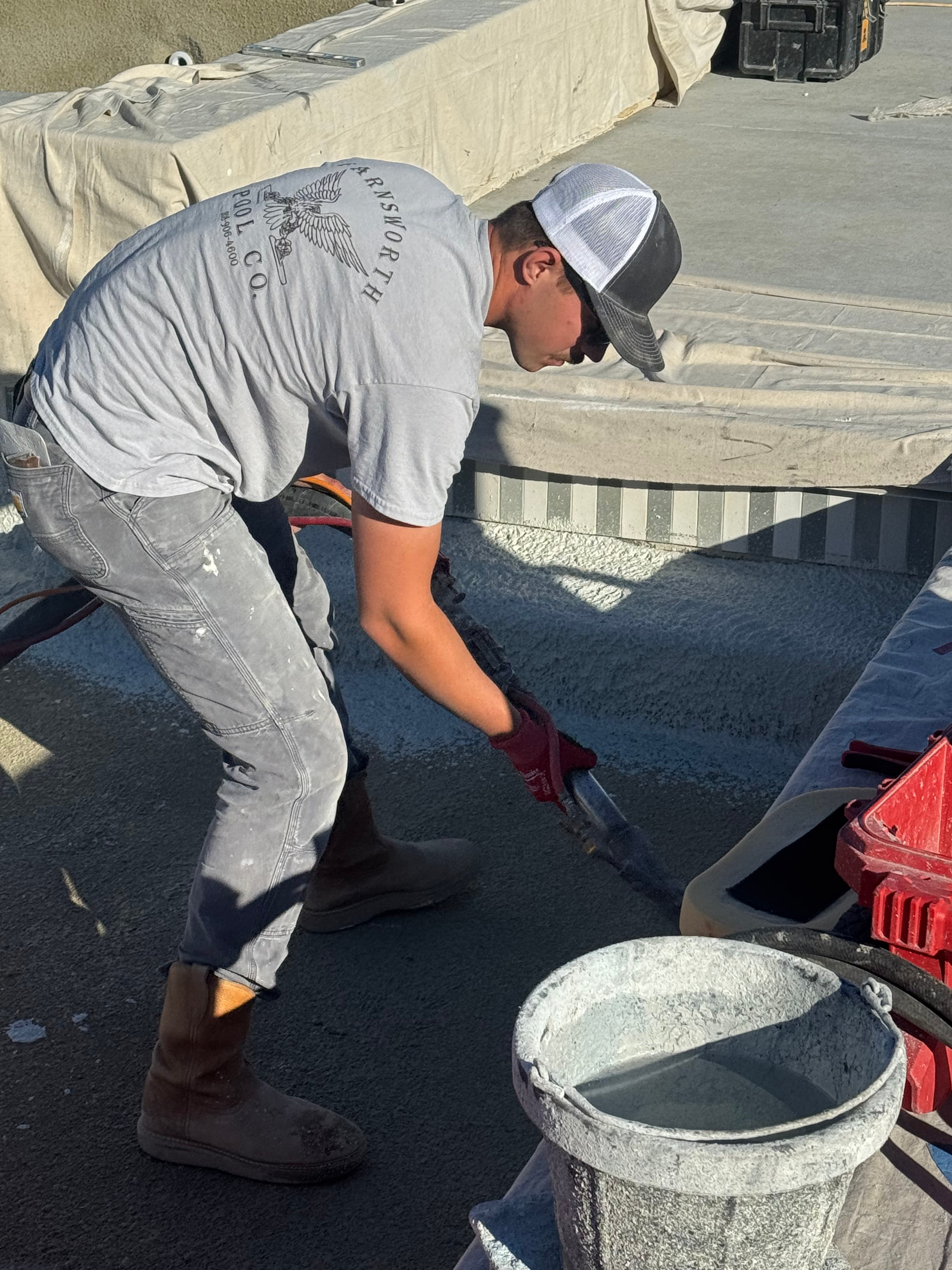 Cael Farnsworth working pool plaster on site