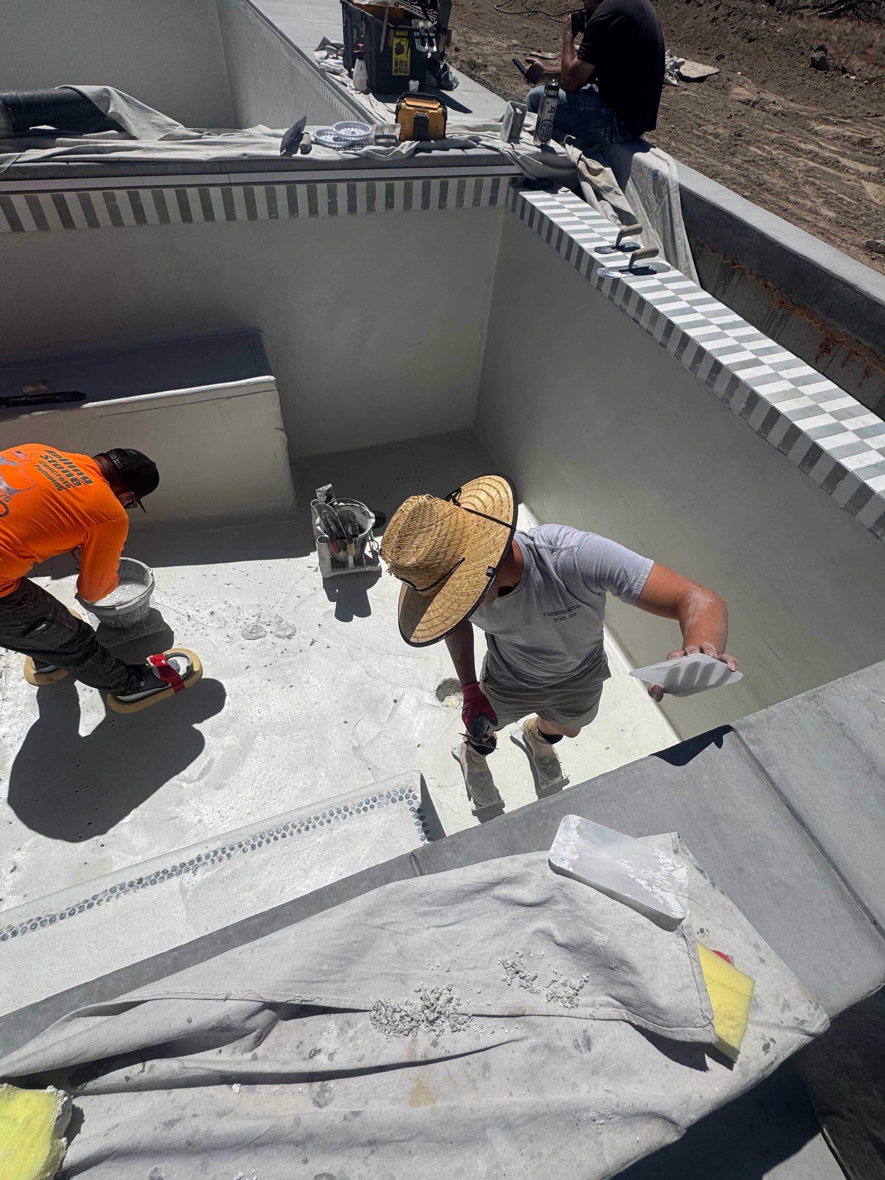 Farnsworth Pool Co. crew plastering a pool interior